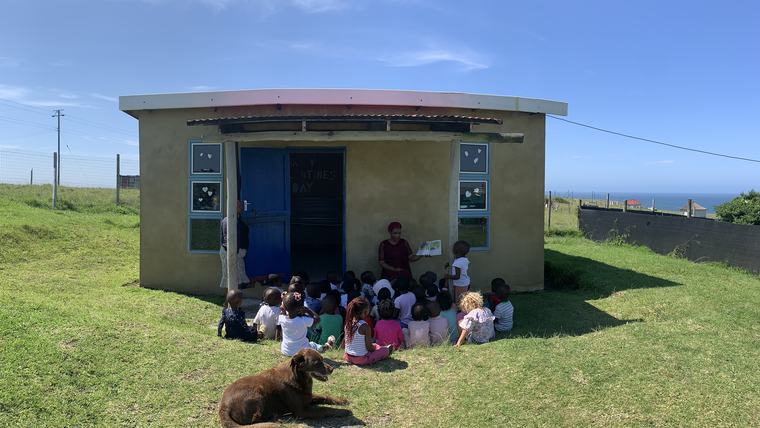 students reading outside library