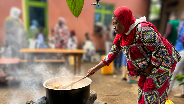 woman cooking over fire