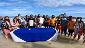 Group photo taken during the MOU signing by the beach in Bohol.