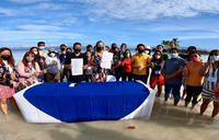Group photo taken during the MOU signing by the beach in Bohol.