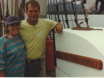Two people standing on a boat in Fiji.