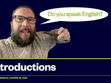 A bearded man holding a pipe with a speech bubble asking "Do you speak English?"