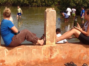 Alexx organized an eco-tourism trip for students, shown here catching fish.