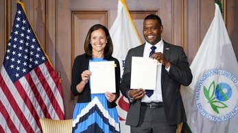 Peace Corps Director Carol Spahn and EPA Administrator Regan holding up a signed MOU
