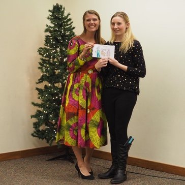 Peace Corps Volunteer Rachel Wallace with an Edison student and one of the books created for students in Senegal.