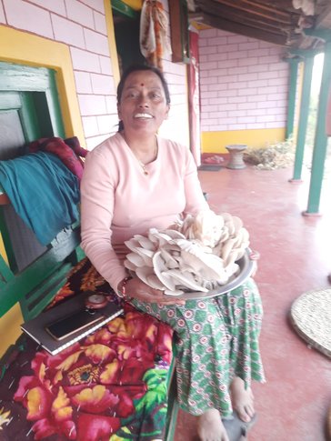 Binu with her mushroom harvest