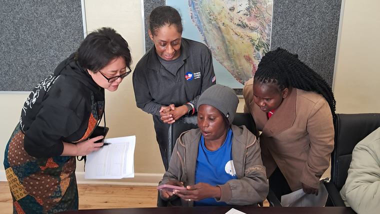 Melanie brainstorms with local stakeholders on a community project.