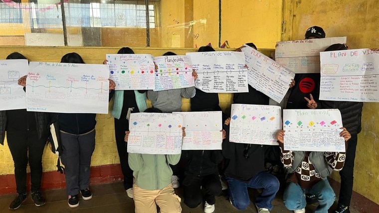 A group of Guatemalan students show off their life plan projects.