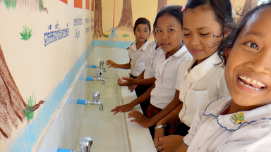 Primary school students washing their hands