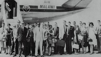 Peace Corps Volunteers in front of plane.