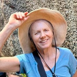 white woman holds her sun had while smiling at the camera