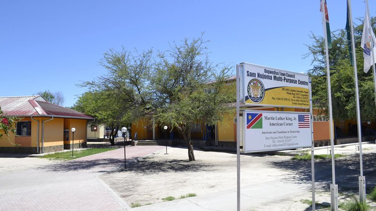 Photo of buildings with a Sam Nujoma Multi Purpose Centre sign in front