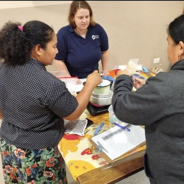 Scarlett facilitates a cooking class in Paraguay.