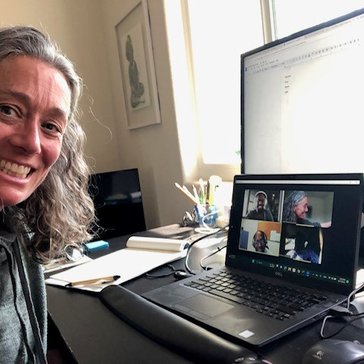 A blonde woman joins a virtual meeting