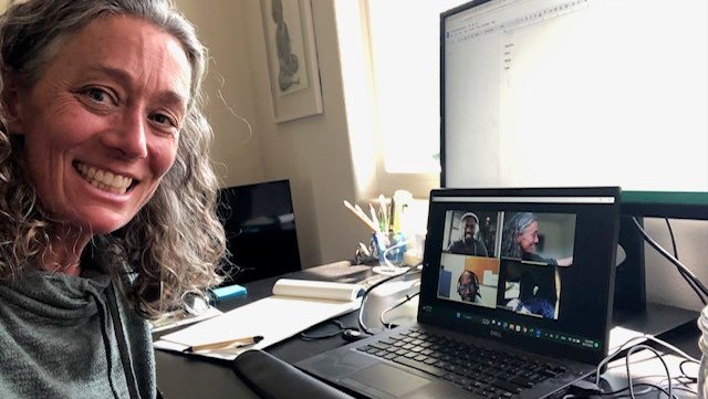 A blonde woman joins a virtual meeting