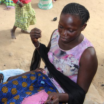 Sewing her first rice bag polypot.