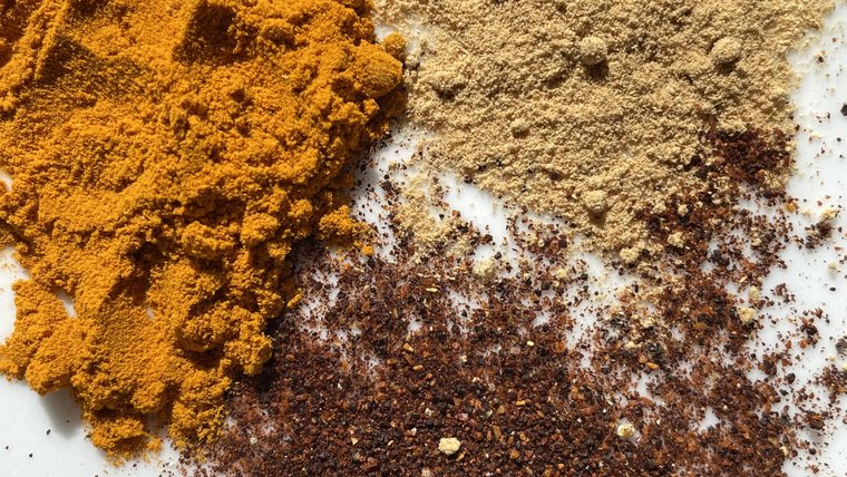 Three different cooking spices appear in piles