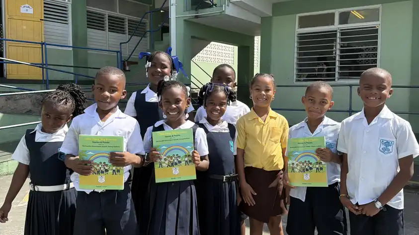 Students proudly display their newly published book