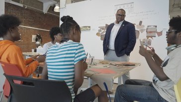 A group of students working on a project at a table.