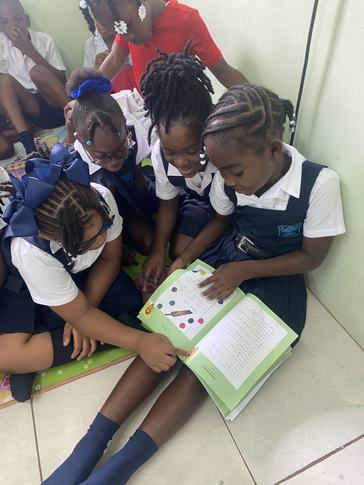 Children eagerly read their own work and the work of their peers in a newly published book.
