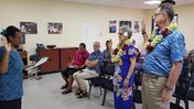 Steve Price and Deborah Buckley raise their right hands as they're sworn in as Peace Corps Response Volunteers in Samoa.