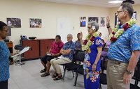 Steve Price and Deborah Buckley raise their right hands as they're sworn in as Peace Corps Response Volunteers in Samoa.