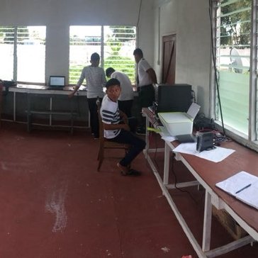 Students and the Hub Technician, Chaission Harris, working on school assignments near the term end.