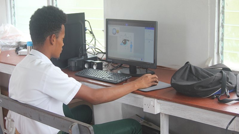 Linford Marks, the Hub Technician in training, practicing his program skills at the computer hub.