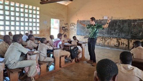 Volunteer facilitating an interactive learning session with students