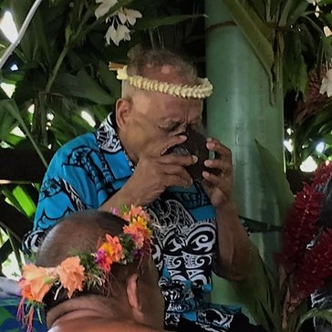 Taking sakau from a traditional half coconut shell