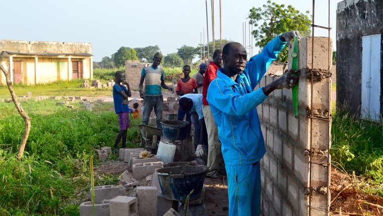 The head mason, Mortalla Diop, constructing the wall.jpg