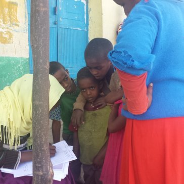 Children receive their trachoma prophylaxis medications at the annual trachoma campaign.