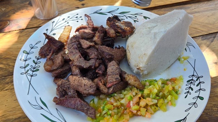 Sam enjoys a traditional Namibian dish called kapana, which features grilled beef.
