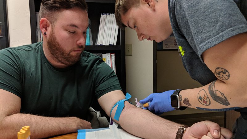 A nurse takes blood for HIV testing