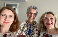 Three women wear traditional, embroidered Ukrainian blouses