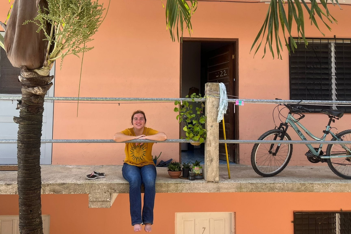 volunteer in front of her home