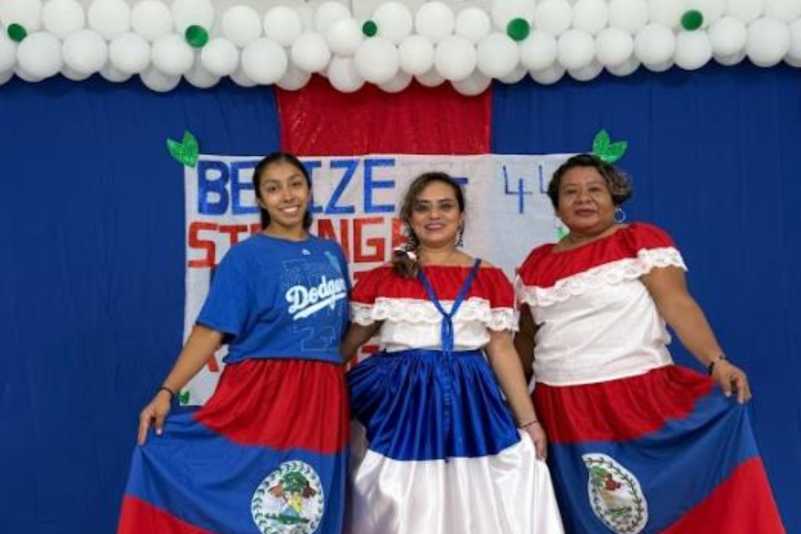 volunteer with her community counterparts in national colors