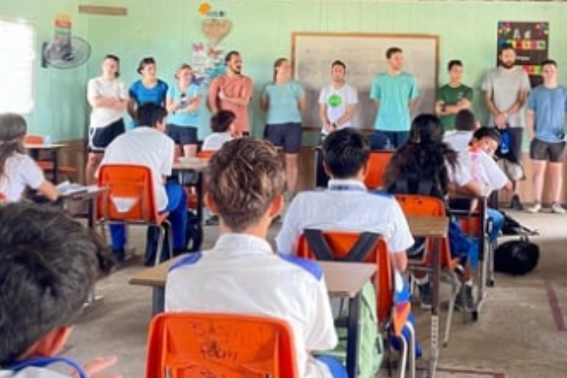 trainees in the classroom with students at their desk