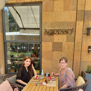two women sit down for coffee