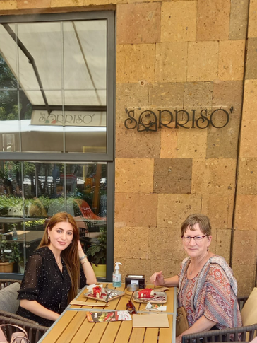 two women sit down for coffee