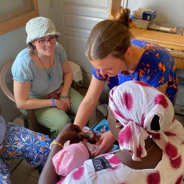 At a health post in Senegal, Lindsey assists with childhood vaccinations and baby growth monitoring.