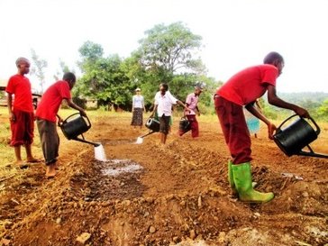 PermaGarden Club members prepared soil beds using compost, charcoal and water.