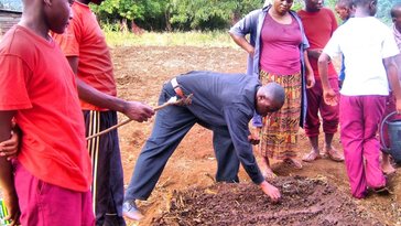 Mr. Benedict demonstrates how to sow seeds in a PermaGarden vegetable bed