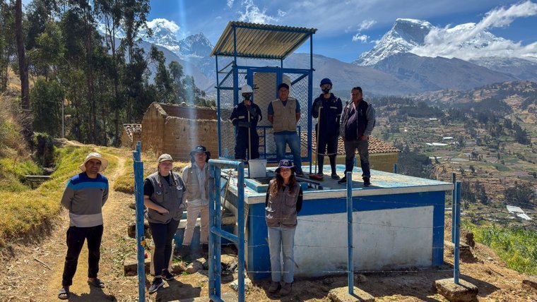 WASH Volunteers cleaning a reservoir with their counterparts