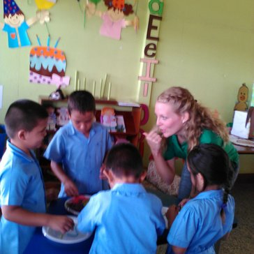 PCV Emily and children working to fill buckets