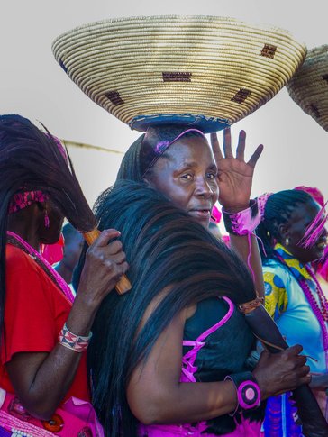 My Namibian mother bringing a gift on her head to the bride and groom.