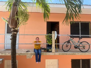 volunteer in front of her home