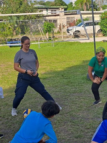 volunteer and staff leading a physical education class
