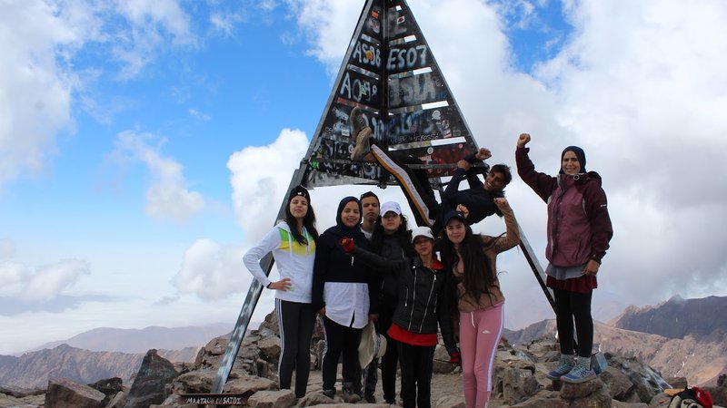 Youth celebrating reaching the top of Toubkal during a CLIMB project