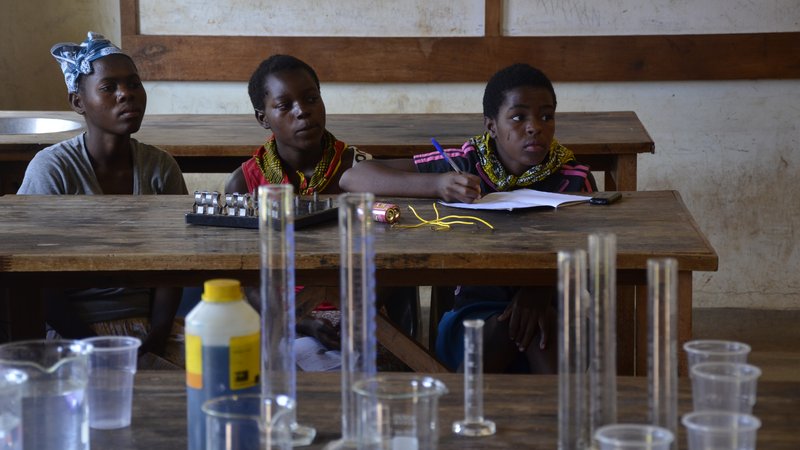 Three Malawian girls learn Chemistry at a STEM camp